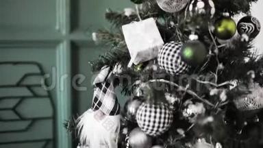 圣诞树上装饰着黑白银的玩具，礼物，球..